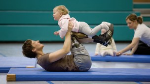 Kathy doing gymnastics with her child